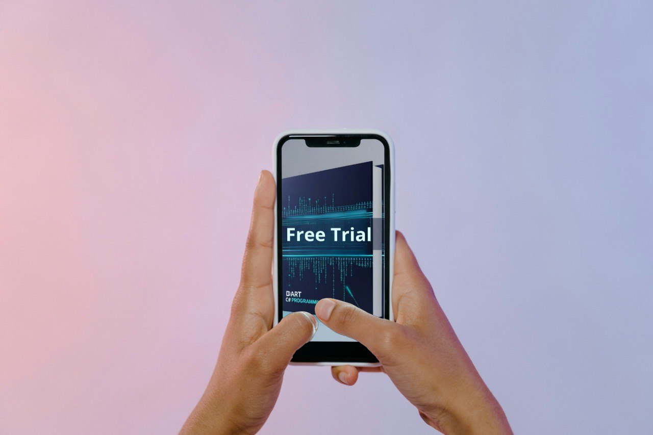 Hand holding a smartphone with 'Free Trial' on the screen against a gradient background