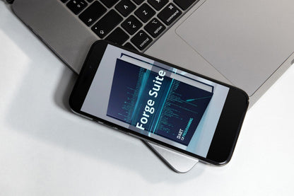 Smartphone displaying 'Forge Suite' on a laptop keyboard